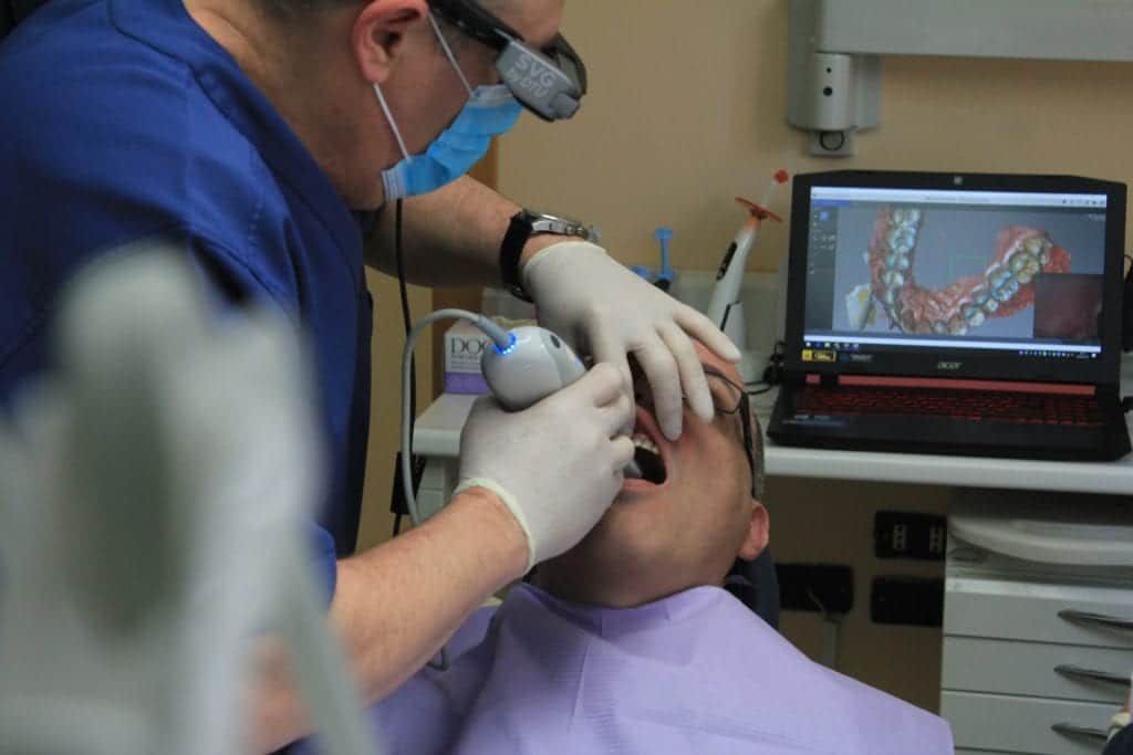 image of dentist taking digtal images of patient's teeth