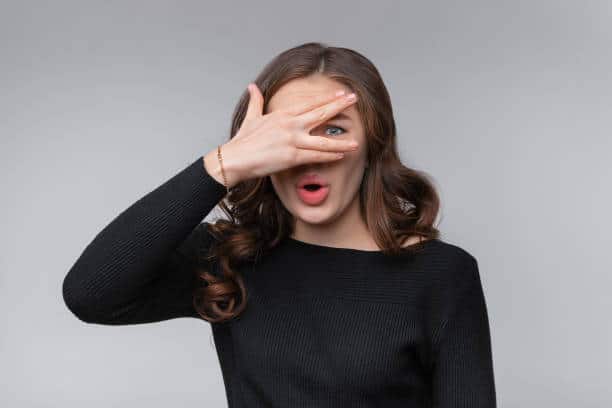 surprised girl covering eyes
