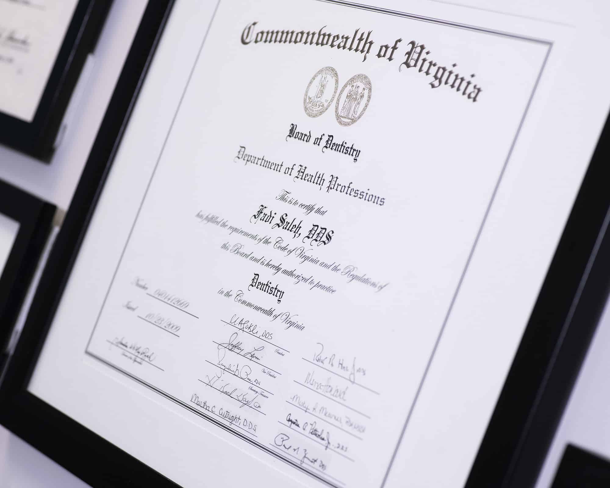 Framed certificate from Commonwealth of Virginia displayed on dark background at Lake Ridge Orthodontics office.