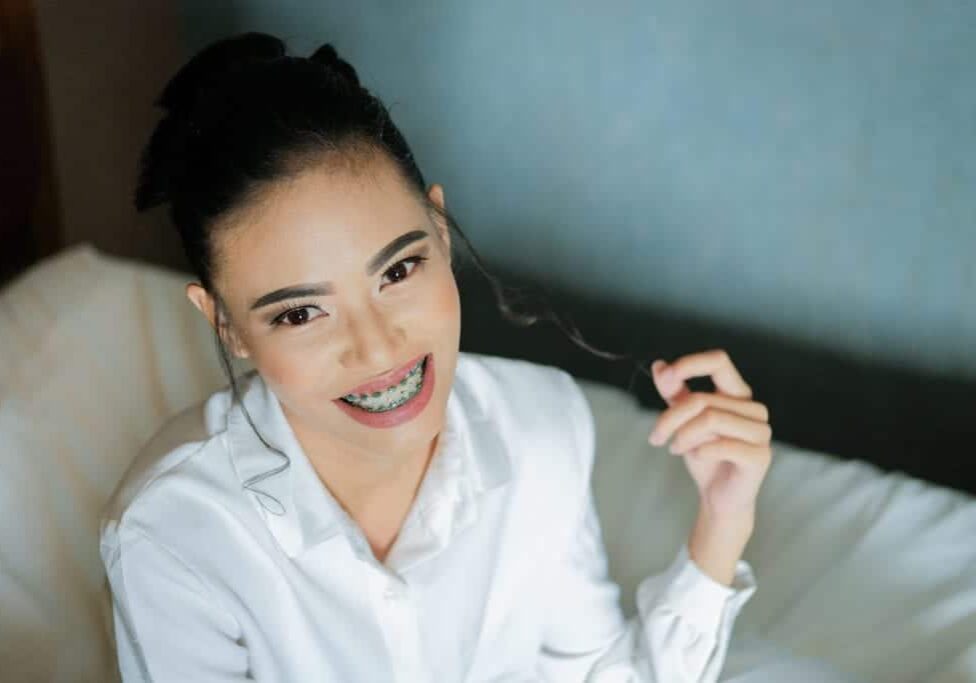 woman with braces in white shirt